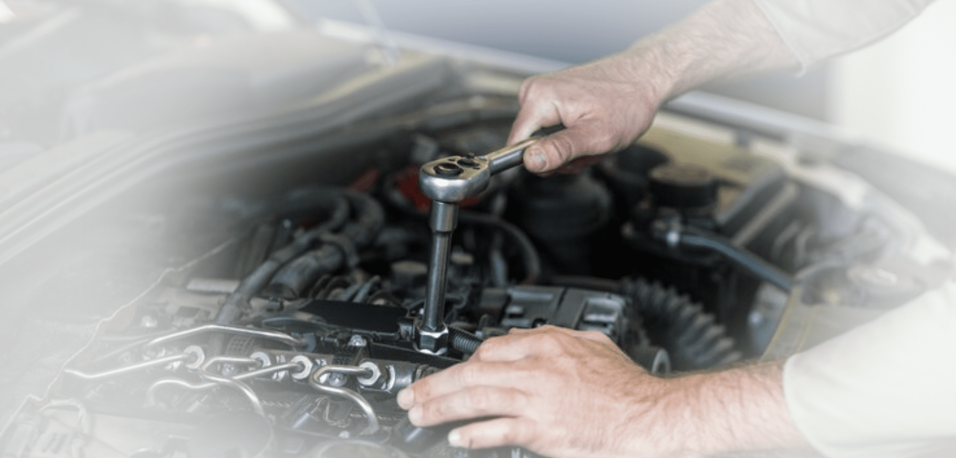 Hands of mechanic servicing a car Hands of mechanic servicing a car<br />